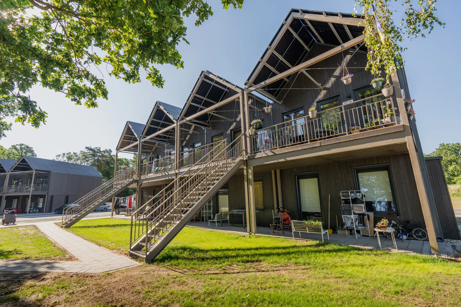 Thimo365 — a multi-storey timber apartment building with balconies and external staircases
